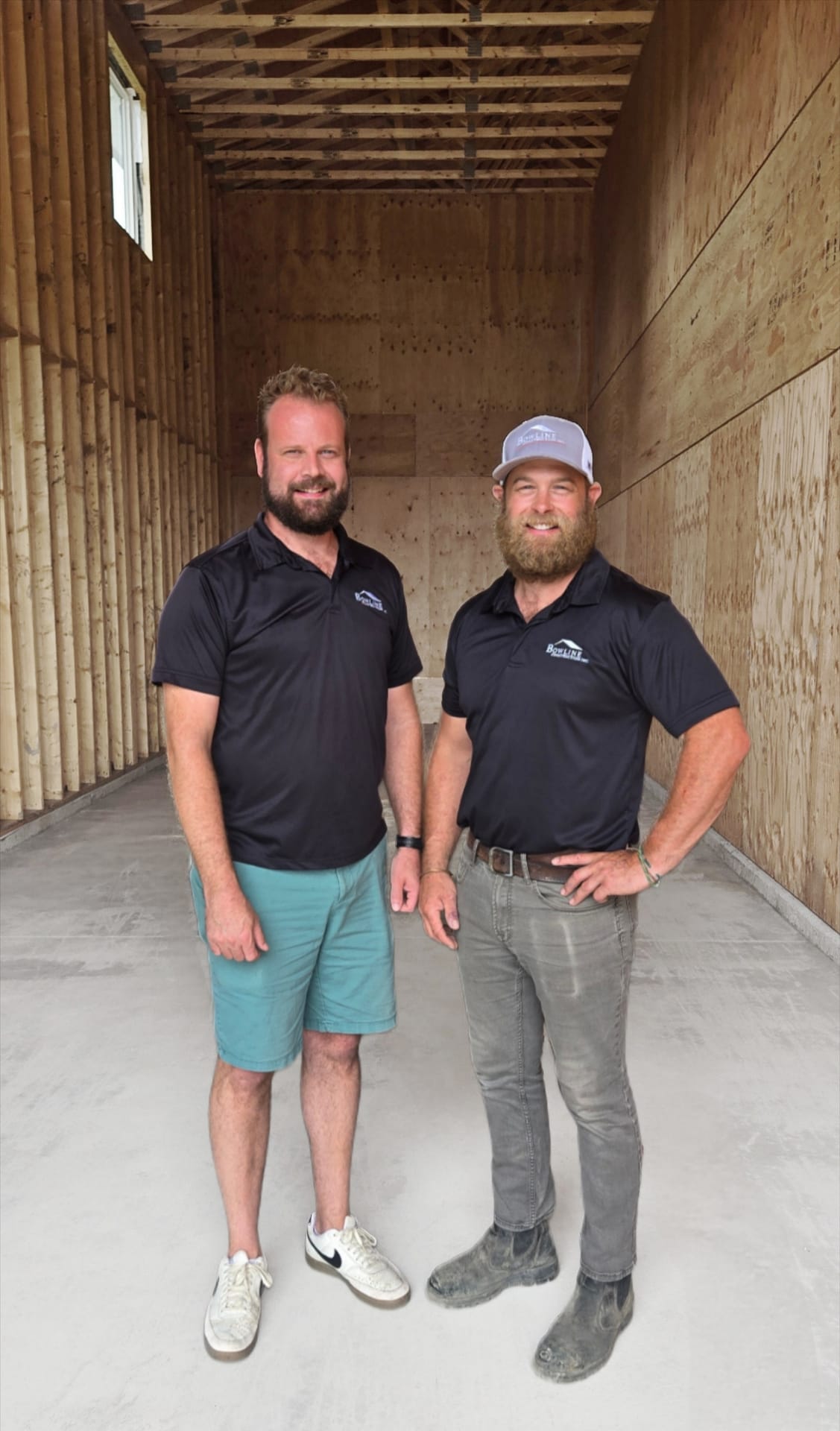Owners of Bowline Construction in Langley BC standing in construction of a structure. 