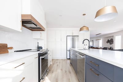 Bright white kitchen with shaker cabinets, gold hardware, and stainless steel appliances installed by Bowline Construction kitchen renovation contractor in Langley, BC