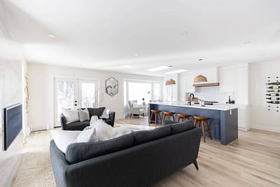 Contemporary kitchen featuring a blue island with seating, pendant lights, and skylights by Bowline Construction kitchen renovation contractor in Langley, BC