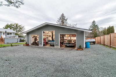 A large, detached garage outbuildings with two car bays and a gravel driveway by Bowline Construction in Langley, BC