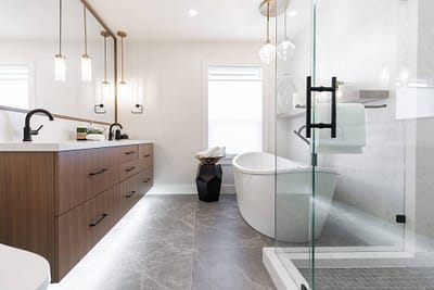 bathroom featuring a freestanding tub, a glass shower, and pendant lights by custom home builder langley, BC