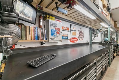 A well-organized workshop with a large workbench, tool cabinets, and shelves stocked with supplies in Langley, BC