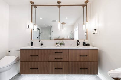 Bathroom featuring a double vanity with a large mirror and pendant lighting by Bowline Construction design-build contractors in Langley, BC