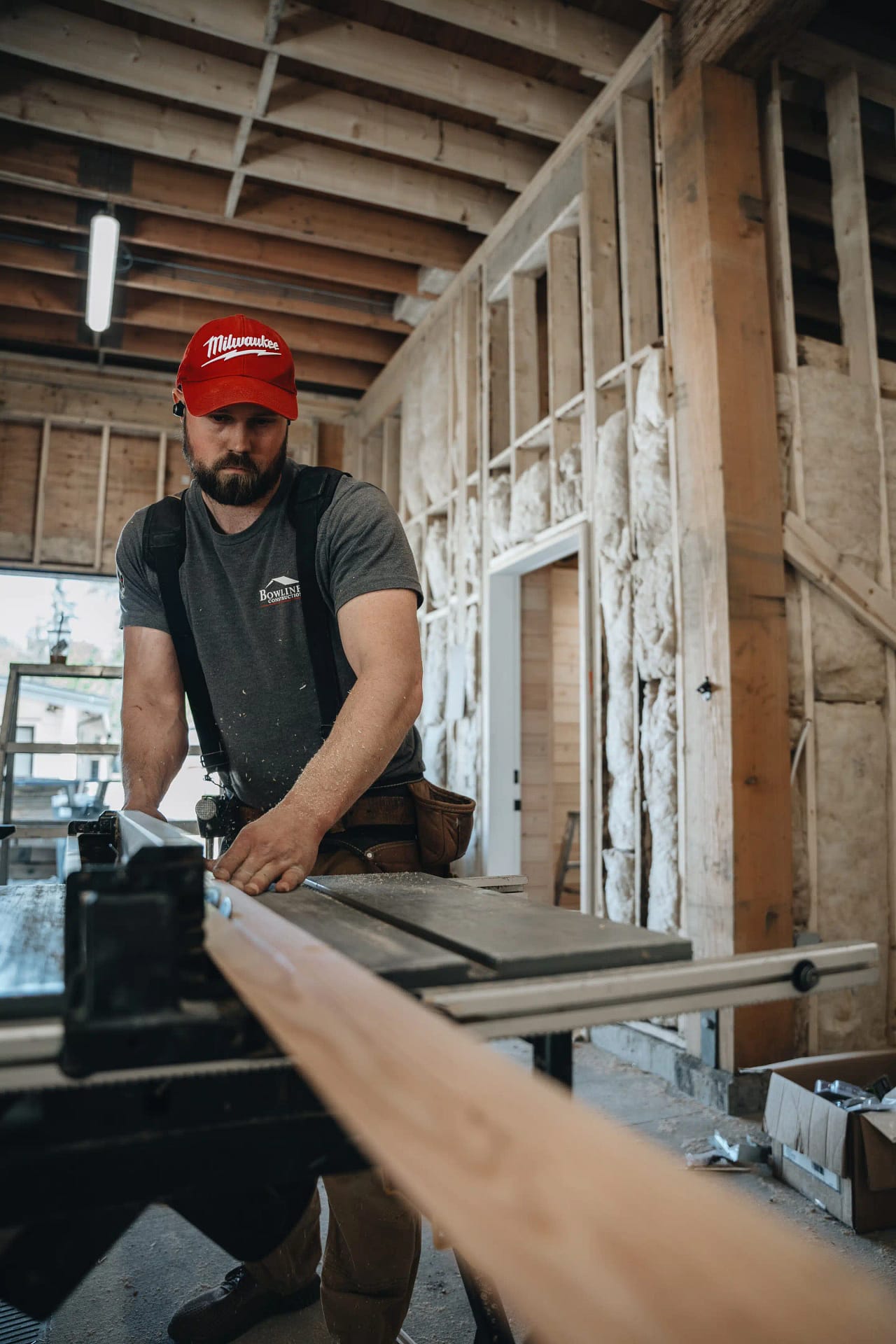 Contractor planing wood plank in construction site by Bowline Construction Langley, BC