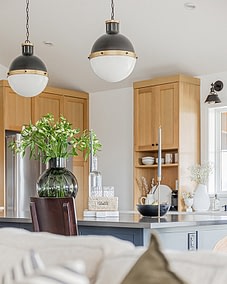 A modern kitchen with natural flowers and a natural light, showcasing the expertise of a skilled kitchen renovation contractor custom home builds in Langley, BC