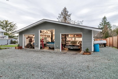 A pole barn with cars inside by pole barn construction in Langley, BC