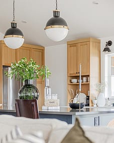 A modern kitchen with natural flowers and a natural light, showcasing the expertise of a skilled kitchen renovation contractor custom home builds in Langley, BC