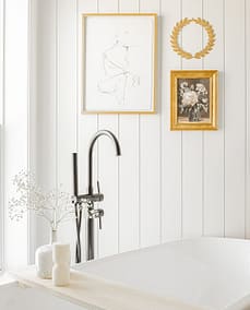 An image of a bathroom with a faucet and picture frames made by home renovation contractors in Langley, BC