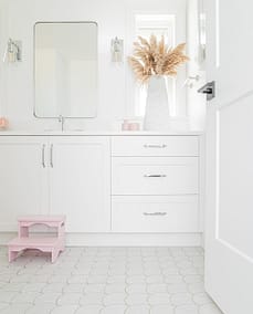 An image of a bathroom with white cabinet made by home renovation contractors in Langley, BC