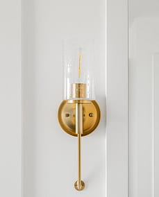 An image of a wall with brass colored lamp with custom additions in Langley, BC