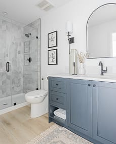 An image of a bathroom with blue cabinet and with other custom additions in Langley, BC