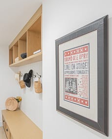 An image of a wall with a picture frame and wooden shelves made by home renovation contractors in Langley, BC