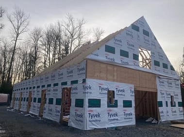 A pole barn under construction with Tyvek HomeWrap by Bowline Construction in Langley, BC