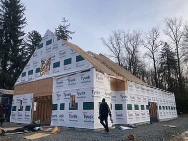 A pole barn under construction with Tyvek HomeWrap by Bowline Construction in Langley, BC