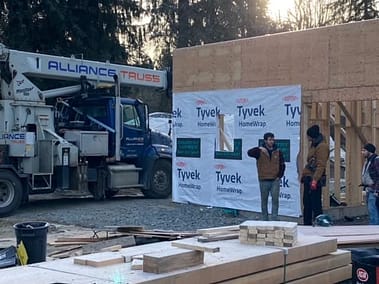 A pole barn under construction with the roof framed and covered in Tyvek house wrap by Bowline Construction in Langley, BC