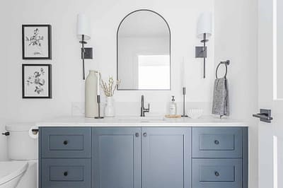 An image of a bathroom with blue cabinet and with other custom additions in Langley, BC