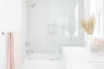 A picture of a bathroom with white countertop and a bathtub made by custom home builder Langley in Langley, BC
