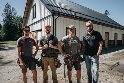 Bowline Construction team members behind a recently constructed pole barn in Langley, BC