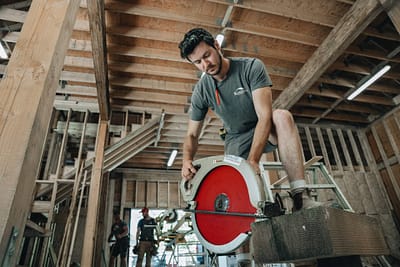 Bowline Construction team staff in a process of cutting wood for pole barn construction in Langley, BC