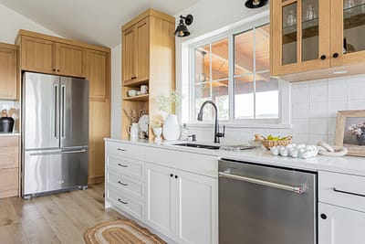A kitchen featuring light wood cabinets and drawers.