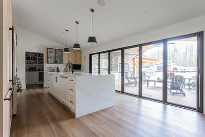 A bright, modern kitchen featuring light-colored wood cabinets.