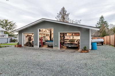 A pole barn with cars inside by pole barn construction in Langley, BC