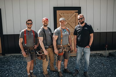 Bowline Construction team members behind a recently constructed pole barn in Langley, BC