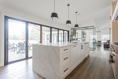 A kitchen with a quartz countertop and sliding doors