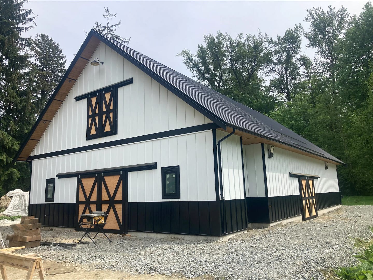 Modern black and white agricultural building with barn-style doors in Langley, BC