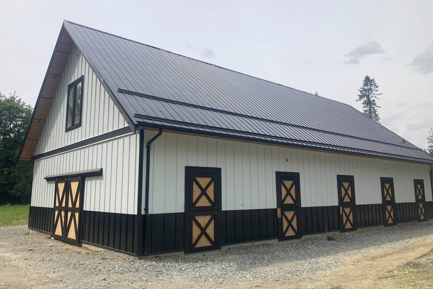 Modern barn with a sleek design and multiple stalls by agricultural building contractors in Langley
