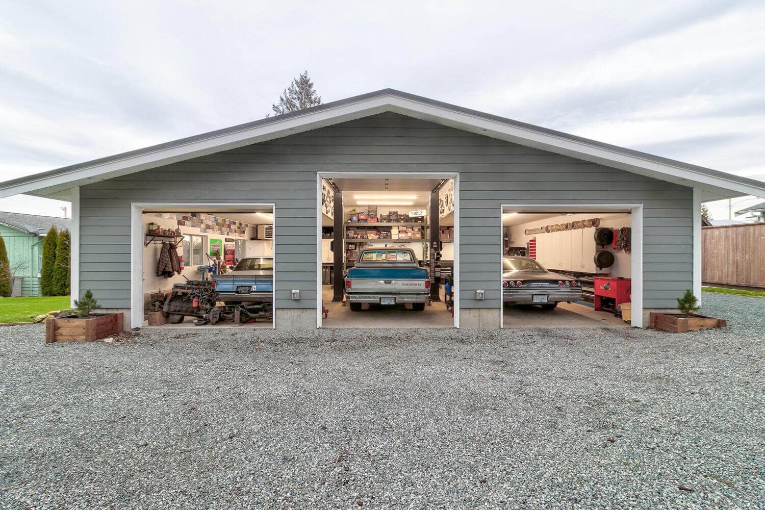 A gray outbuilding with three garage doors in Langley, BC