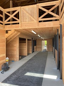 Spacious horse barn with multiple stalls, a loft, and ample ventilation by agricultural building contractors in Langley.
