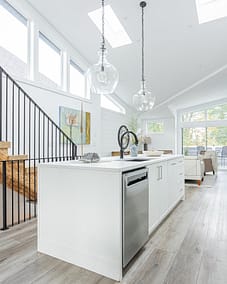 A white accent kitchen with modern industrial kitchen equipment by kitchen renovation contractor in Langley, BC