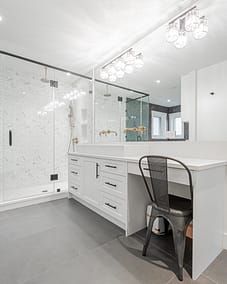 Modern white kitchen cabinetry with black hardware, commonly used by home renovation contractors in Langley