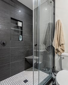A modern bathroom with a glass-enclosed shower.