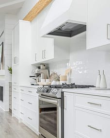 A white accent kitchen with modern industrial kitchen equipment by kitchen renovation contractor in Langley, BC