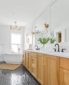 A bathroom with two faucets and a white marble sink and a bathtub made by home renovation contractors in Langley, BC