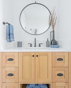 An image of a bathroom faucet with wooden countertop made by a home renovation contractors in Langley, BC