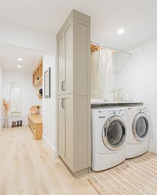 A picture of a laundry area with washing machines, cabinet made by a custom home builder langley in Langley, BC