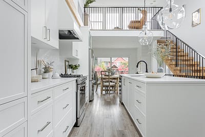 A white accent kitchen with modern industrial kitchen equipment by kitchen renovation contractor in Langley, BC