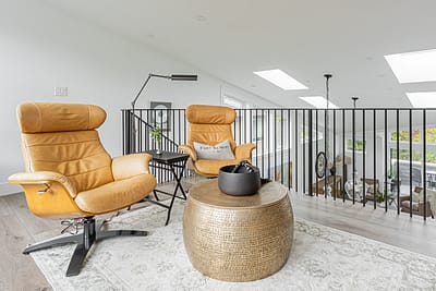 A second floor entertainment area with custom addition couch