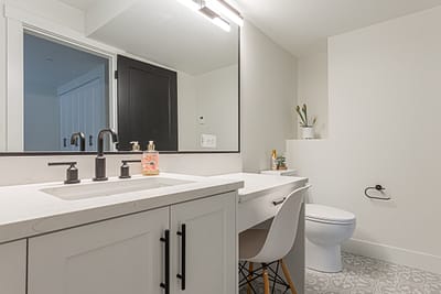 A modern bathroom vanity with white cabinets
