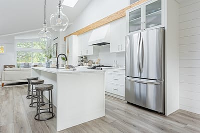 A white accent kitchen with modern industrial kitchen equipment by kitchen renovation contractor in Langley, BC