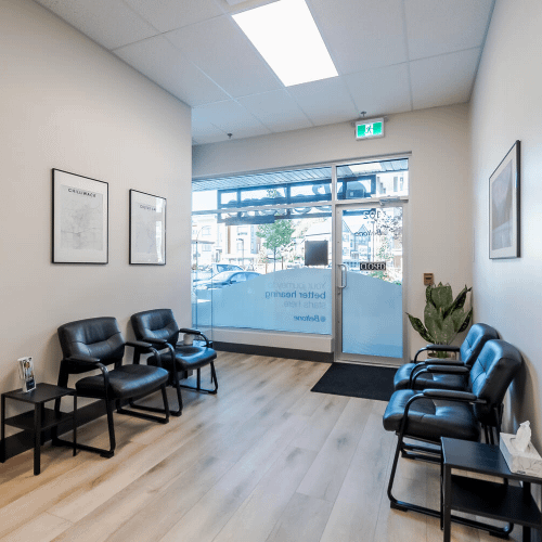 Waiting area with glass entry and black seating created by Bowline Construction for a commercial tenant improvement in Langley, BC